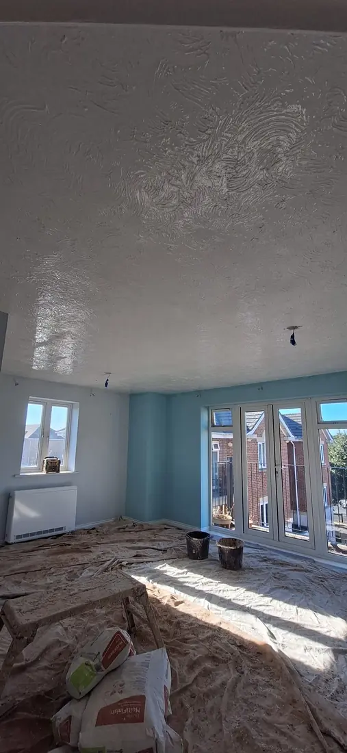 Swirl-textured Artex ceiling before it was skimmed flat
